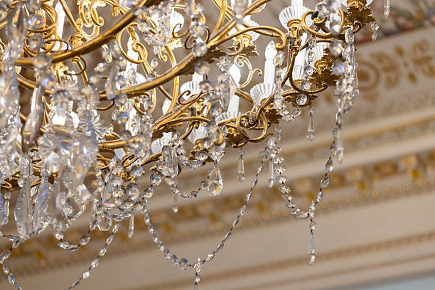 istock Antique golden crystal chandelier sparkling under bright lights 2203603481