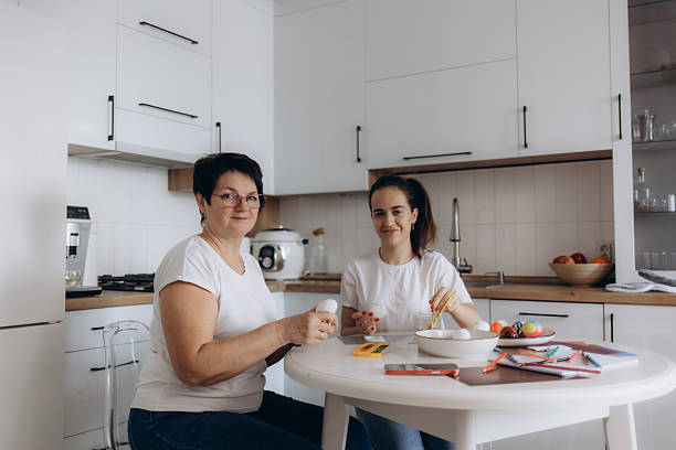 istock Family Bonding While Painting Easter Eggs in a Modern Bright Kitchen 2203605282