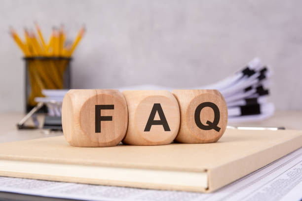 istock wooden blocks spelling 'FAQ' on a book, symbolizing customer support, information, and online help 2203607921