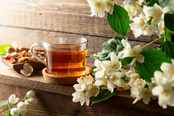 istock Herbal tea and blooming jasmine branch. 2203608720