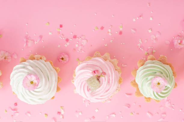 istock pink and green cupcakes with spring flowers  on pink  background 2203608821