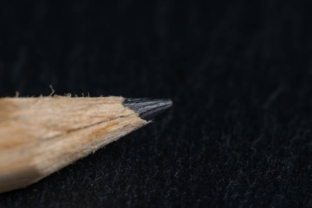 Close up wooden pencil on black background. Selective focus