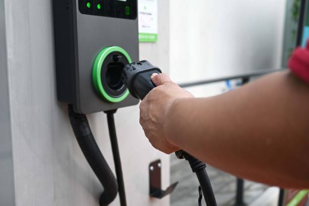 istock Man recharge EV electric vehicle battery from EV charging station. 2203610410