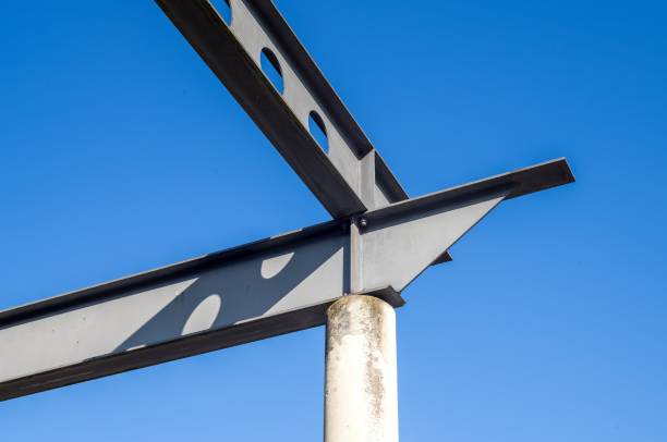 istock Steel girders forming framework against blue sky 2203610492