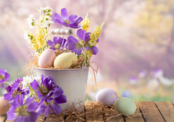 a bouquet of blooming spring flowers and Easter eggs on a wooden table, Poland