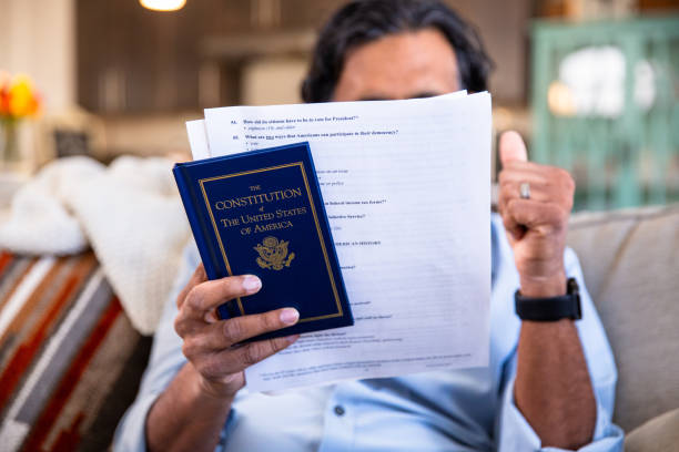 Immigrant studying for US Citizenship at home stock photo