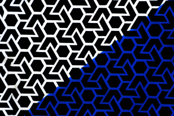 A geometric pattern in black and white, partially colored blue, showcasing a hexagon and angled line design element.