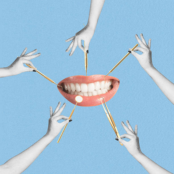 istock Many hands holding dentist tools in front of woman mouth 2203614017