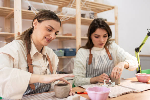 istock Women making handmade clay products at pottery workshop 2203615365
