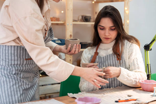 istock Female friends at pottery workshop 2203616675
