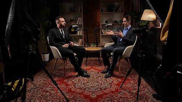 Two experts talking in a cozy, loft-style podcast studio