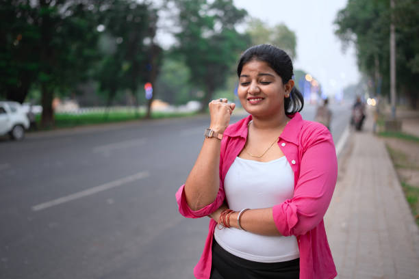 istock Thoughtful Young Woman Standing by the Roadside 2203617984