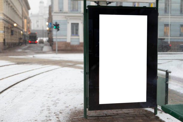 istock Digital display with copy space at a tram stop on a snow-covered city street 2203618493