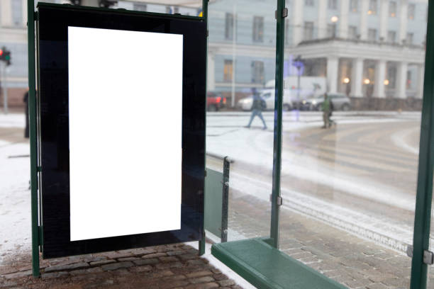 istock Digital display with copy space at a tram stop on a snow-covered city street 2203618525