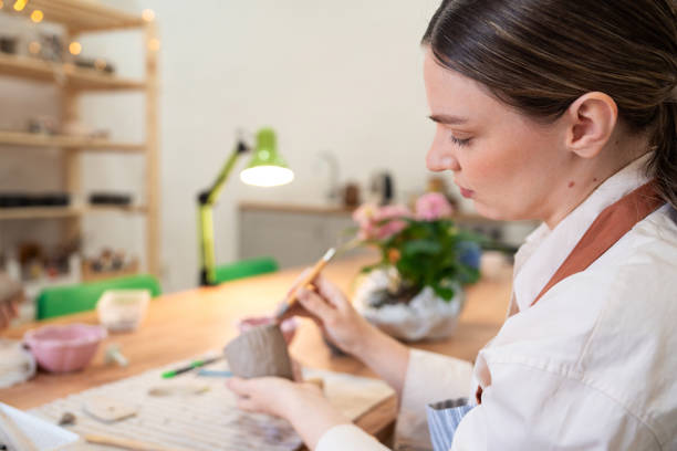 istock Woman using clay to make handmade mug at pottery studio 2203618665