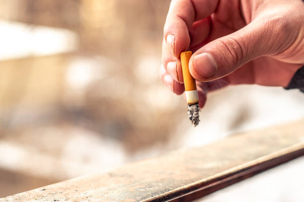 istock Male hands holding cigarette butt. Cigarettes. Smoking concept. 2203619067