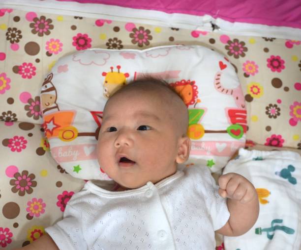 istock Baby lying on the bed 2203620803