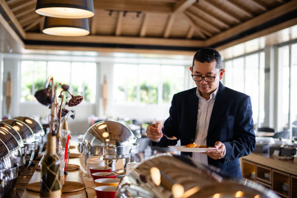 istock Business man at hotel restaurant buffet 2203623141