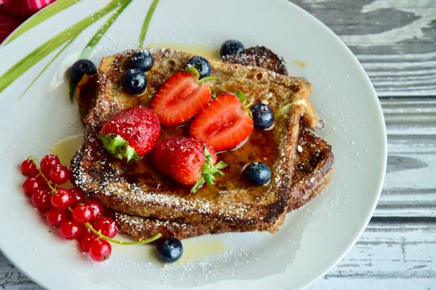istock French toast crowned with vibrant strawberries, Red currant, blackberries 2203623262