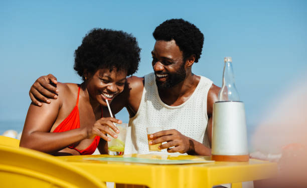 istock Happy couple enjoying a summer date at the beach 2203625608