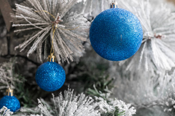 White Christmas tree with  silver shiny balls. City Christmas tree. Christmas background.