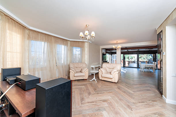 Modern Living Room Featuring Elegant White Leather Furniture with Large Windows and Scenic View