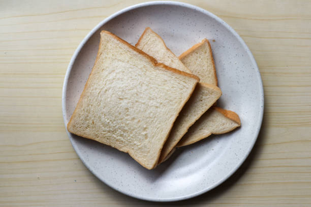istock White plain breads in white plate. Overhead shot of sliced white bread. 2203631934