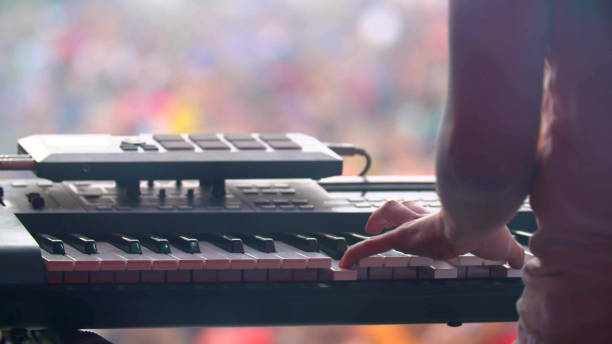 istock man with synthesizer plays music on the concert 2203632312