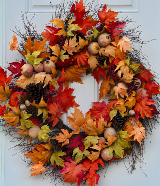 istock Vibrant Autumn Colors on a GrapeVine Wreath, White Door 2203634767