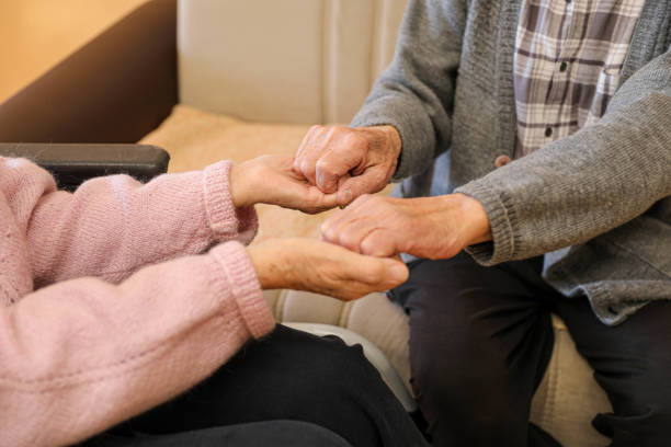 istock Compassionate Care: A Caregiver Holding an Elderly Woman’s Hands 2203636688