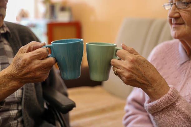 istock Warm Conversation Over Coffee: Elderly Pair in a Nursing Home 2203637458