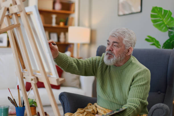 istock Pensioner in daily activities at home, drawing on canvas 2203637499