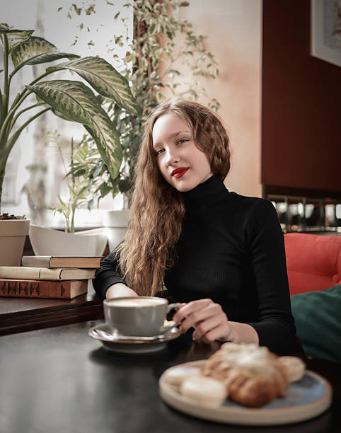 Girl with coffee having breakfast in a coffee shop