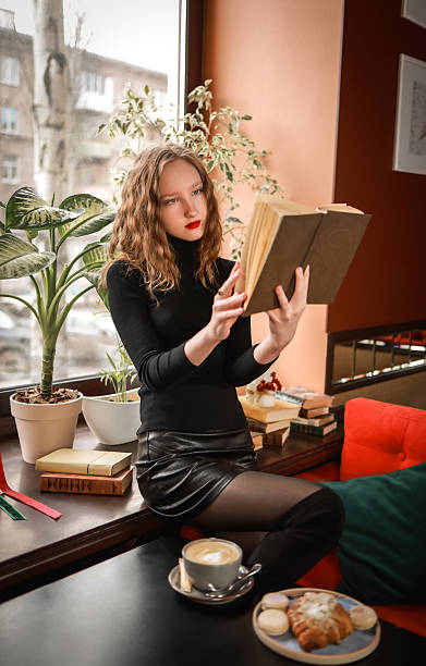 istock Girl with a book in a cafe. 2203637937