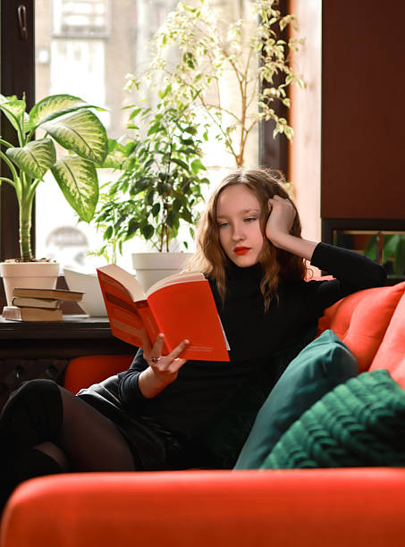 istock Girl with a book in a cafe. 2203638343