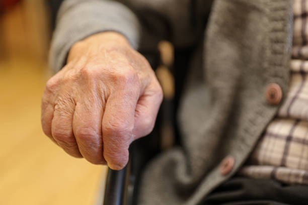 istock Elderly Hand on Wheelchair at a Nursing Home (80+) 2203638651