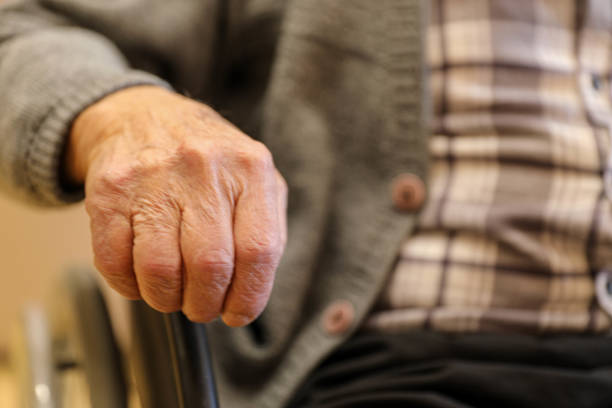 istock Elderly Hand on Wheelchair at a Nursing Home (80+) 2203638872