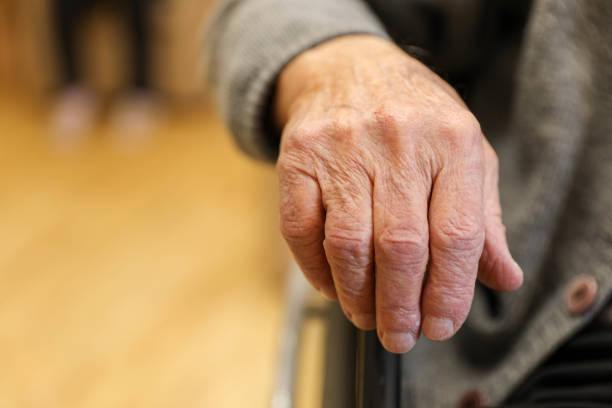 istock Elderly Hand on Wheelchair at a Nursing Home (80+) 2203639046