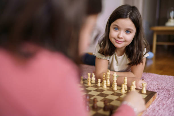 istock Girl playing chess game whit her sister 2203640689
