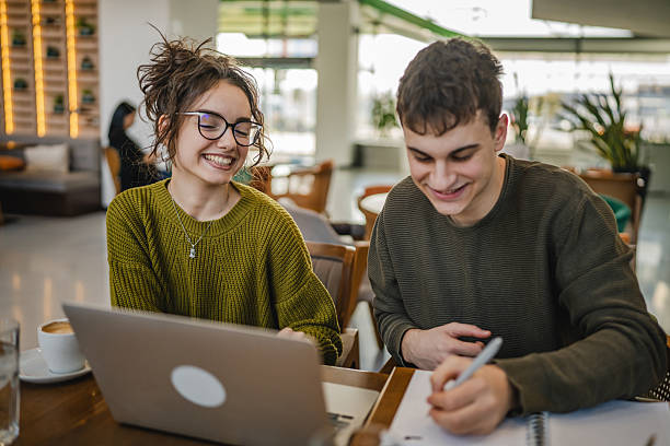 istock young couple work together and learn on laptop at cafe 2203641493