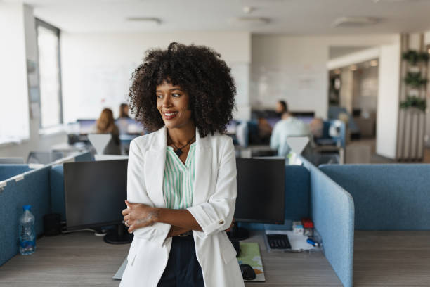 istock Professional Woman Standing in Modern Office Space 2203645348