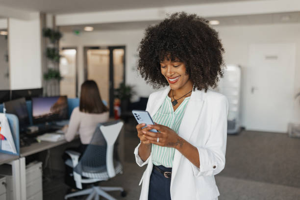 istock Professional Woman Smiling with Mobile Phone 2203645597