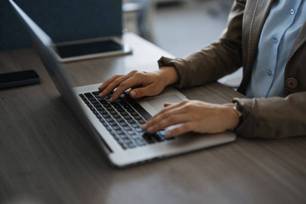 istock Focused Professional Working on Laptop at Office Desk 2203646120
