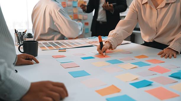 istock Collaborative brainstorming session with sticky notes, diverse team members engaged in creative planning and idea generation in a bright office environment SACTR 2203646253