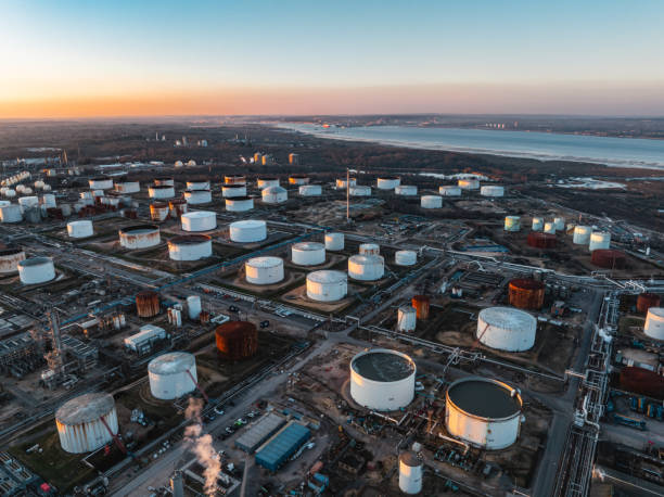 istock Oil refinery plant with storage tanks at sunset captured by drone 2203646285
