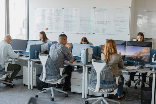 istock Group of Professionals Collaborating in Modern Office 2203646295