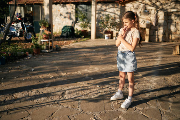 Portrait of a sad girl outdoors stock photo