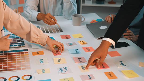 Collaborative Brainstorming Session with Color Swatches and Sticky Notes in a Creative Workspace Environment SACTR