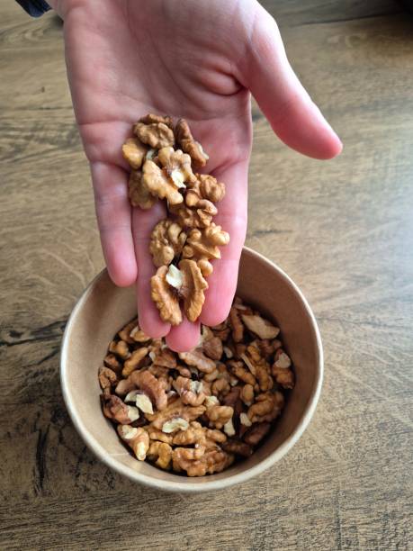 istock Hand holding a bowl of nuts 2203651409