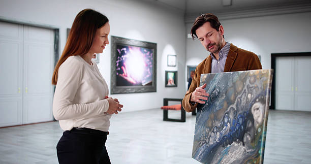 istock Two Young Artists Browse Modern Art Gallery 2203656683